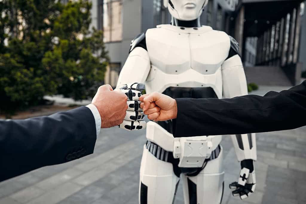 Concept of two businessmen bumping fists with an AI