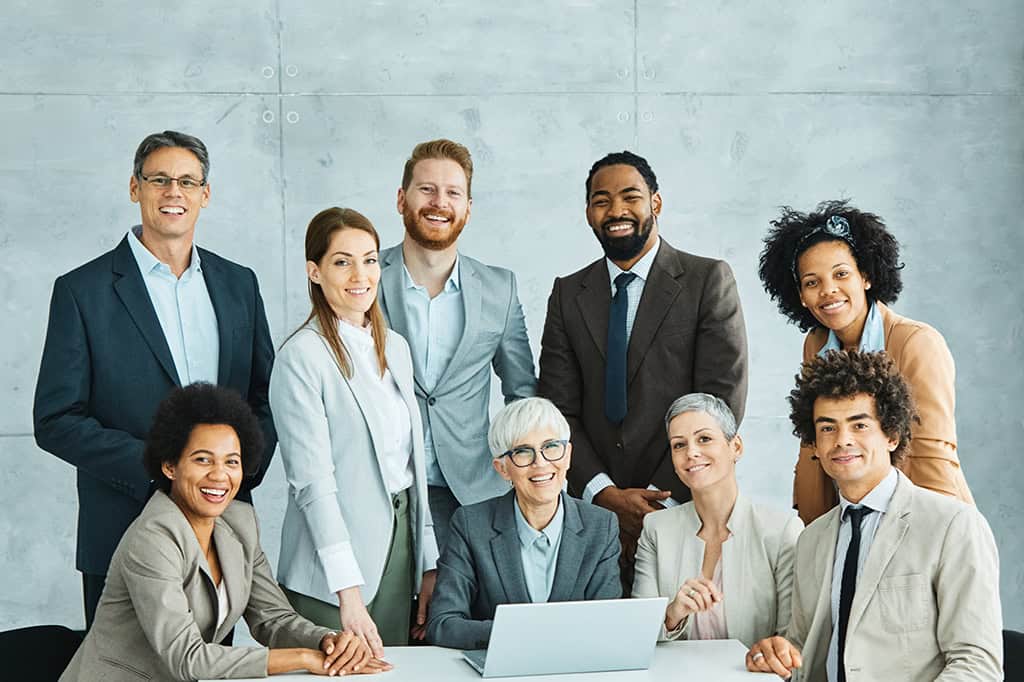 A diverse board of directors at a nonprofit smile after wrapping up recruitment with data-driven hiring.