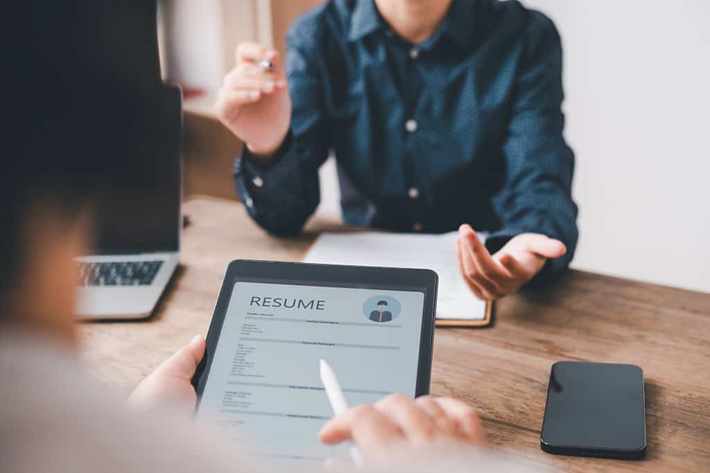 A nonprofit board member manually reviews a resume pre-screened and flagged by AI.