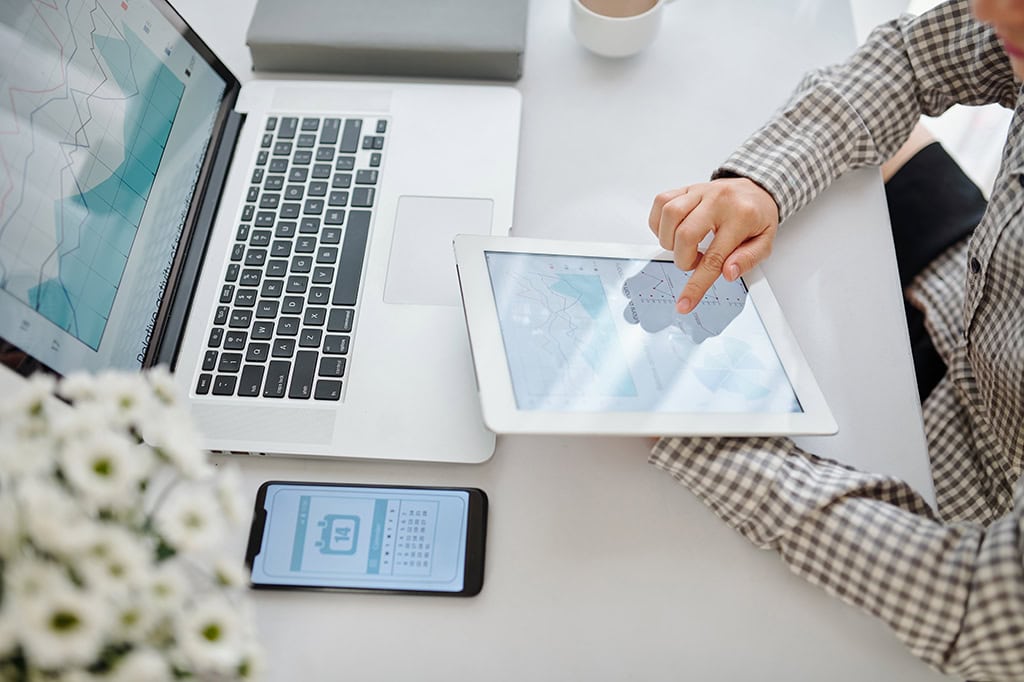 A woman analyzes workflows and business processes to try and determine which cloud computing option is best.