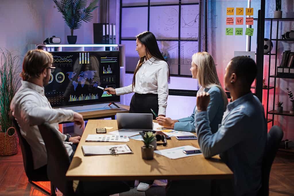 Business partners focus on an interactive whiteboard during a meeting Business partners focus on an interactive whiteboard during a meeting