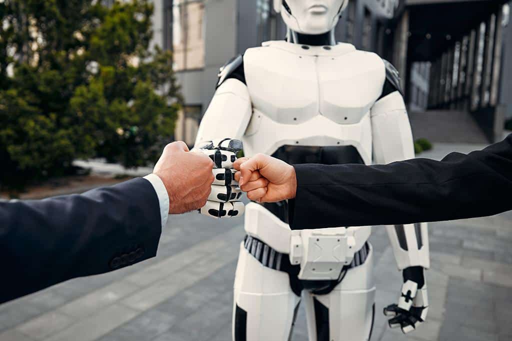 Concept of two businessmen bumping fists with an AI Concept of two businessmen bumping fists with an AI