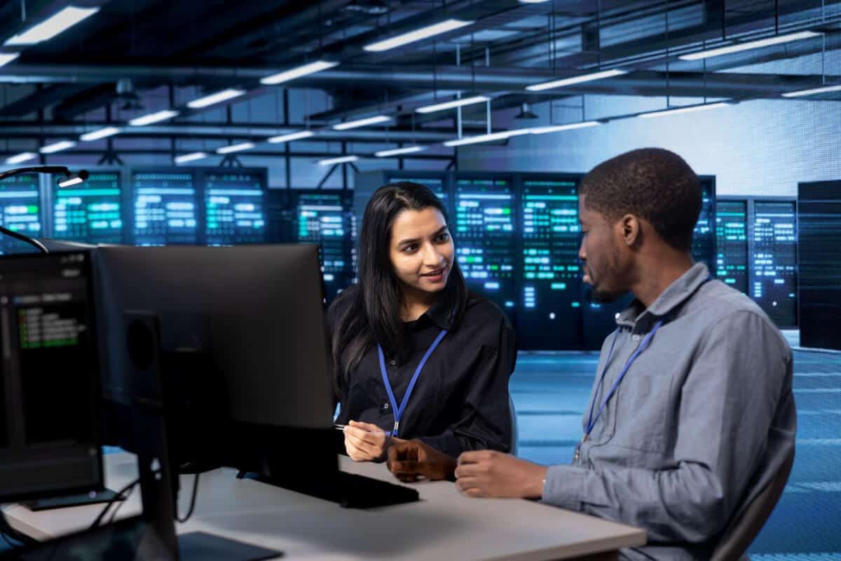 Member of managed services provider advising employee of business about IT best practices
