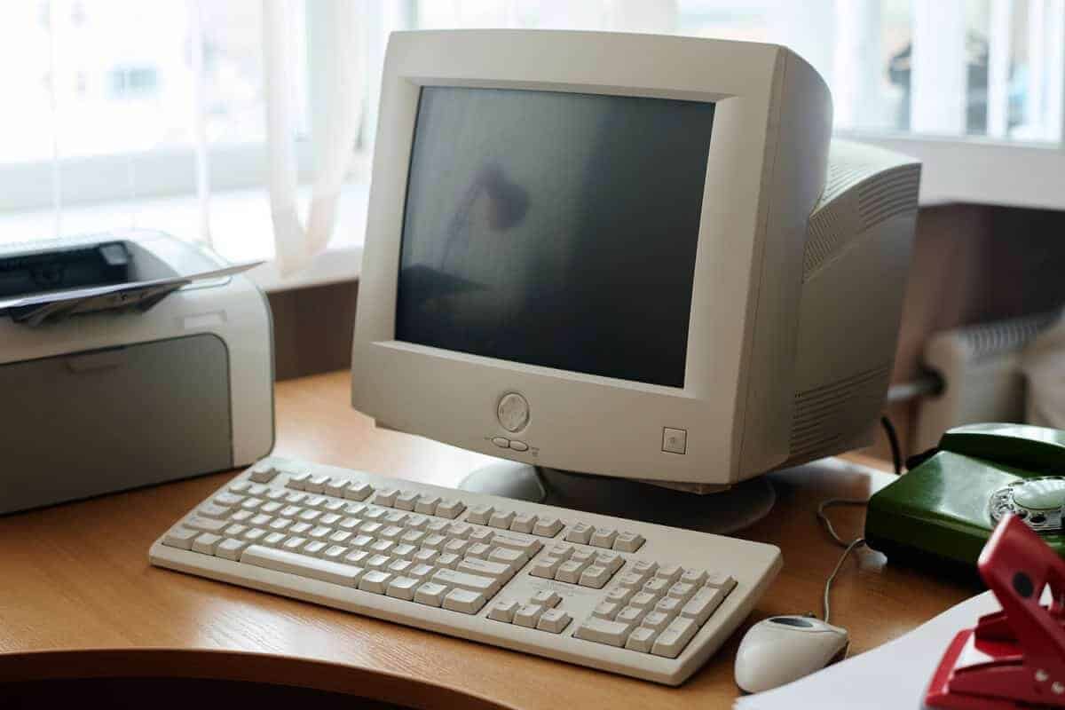 Old computer on desk representing obsolete hardware and IT risk
